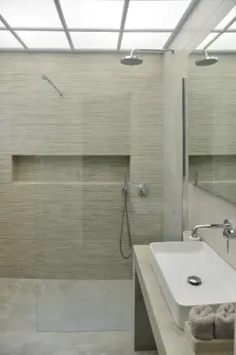 a bathroom with a shower with a sink and a glass shower stall at Athens Destination: a home away from home in Athens