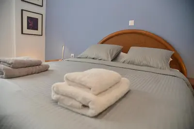 a bed with white towels on top of it at Athens Destination: a home away from home in Athens