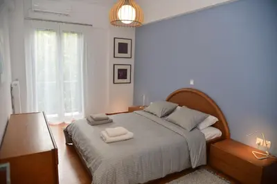 a bedroom with a large bed with two towels on it at Athens Destination: a home away from home in Athens