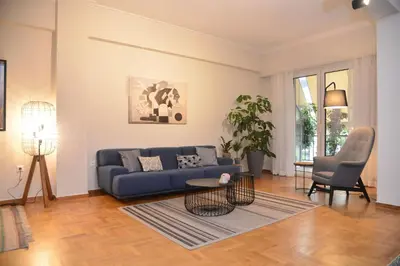 a living room with a blue couch and a table at Athens Destination: a home away from home in Athens