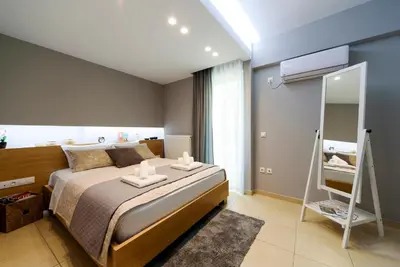a bedroom with a bed with two candles on it at M&D Luxury Suites in central Athens in Athens