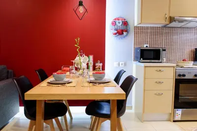 a kitchen with a wooden table with chairs around it at M&D Luxury Suites in central Athens in Athens