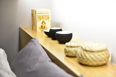 a wooden shelf with two cups and a book at M&D Luxury Suites in central Athens in Athens