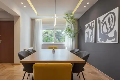 a dining room with a table and chairs at Athenian Grand Riviera Villa in Athens
