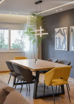a dining room with a wooden table and chairs at Athenian Grand Riviera Villa in Athens