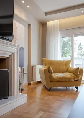 a living room with a couch and a television at Athenian Grand Riviera Villa in Athens