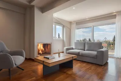 a living room with a couch and a fireplace at Athenian Grand Riviera Villa in Athens