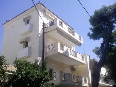 a white building with a balcony on the side of it at My Way Hotel in Athens