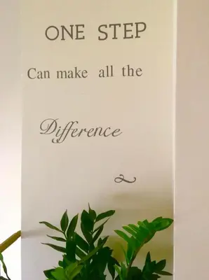 a sign that says one step can make all the difference at My Way Hotel in Athens