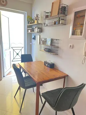 a dining room with a wooden table and chairs at My Way Hotel in Athens