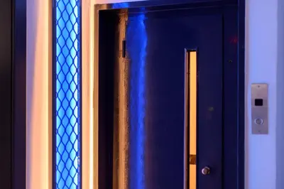a blue door with a metal grate on it at Fos Residential Apartments in Athens