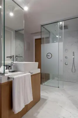 a bathroom with a sink and a shower at Elia Ermou Athens Hotel in Athens