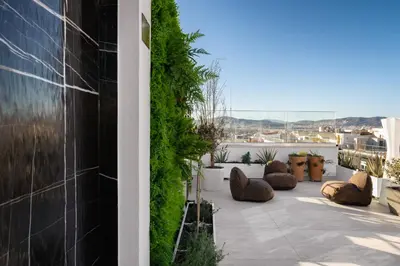 a patio with plants on the side of a building at Elia Ermou Athens Hotel in Athens