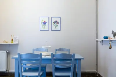 a blue table with four blue chairs around it at M&N Koukaki House in Athens