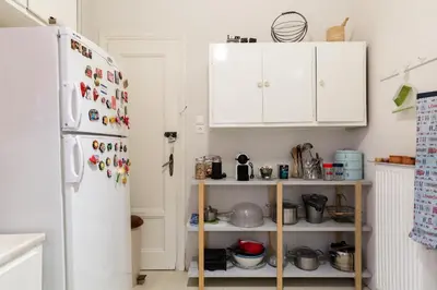 a kitchen with white cabinets and a refrigerator at M&N Koukaki House in Athens