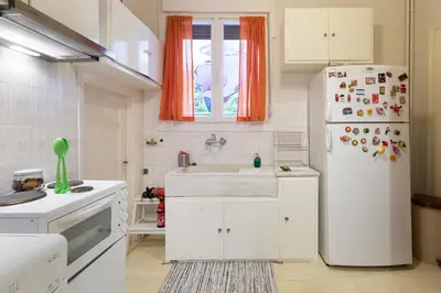 a kitchen with a white refrigerator and a sink at M&N Koukaki House in Athens