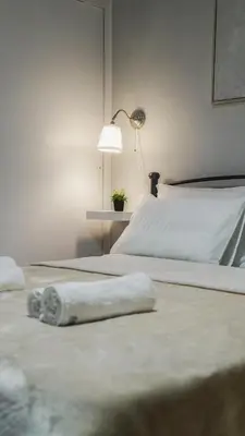 two beds with towels on them in a bedroom at Luxury apartments near Acropolis! in the Heart of Athens! in Athens