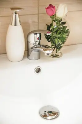 a bathroom sink with a flower vase and a faucet at Luxury apartments near Acropolis! in the Heart of Athens! in Athens