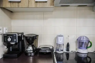 a kitchen counter with various appliances on a counter top at Luxury apartments near Acropolis! in the Heart of Athens! in Athens