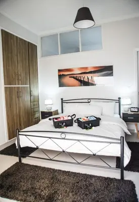 a bedroom with a bed with two bags on it at Luxury apartments near Acropolis! in the Heart of Athens! in Athens