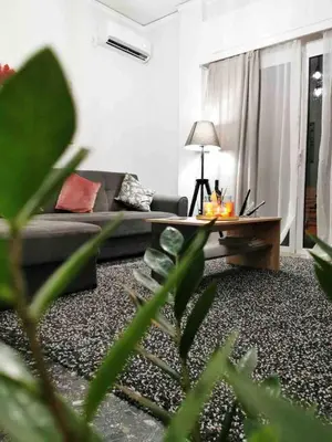 a living room with a couch and a coffee table at Luxury apartments near Acropolis! in the Heart of Athens! in Athens