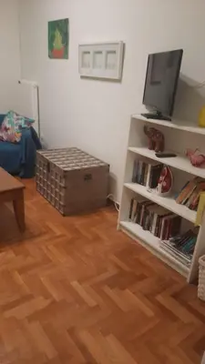 a living room with a tv and a book shelf at By Lycabettus in the city-heart close to Acropolis in Athens