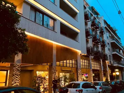 a building with cars parked in front of it at Athens Studios in Athens