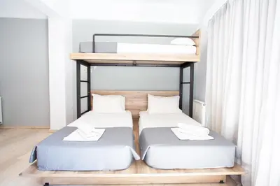 two bunk beds in a room with white walls at Athens Studios in Athens
