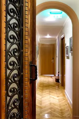 a hallway with a door with an iron gate at Sweet Home Hotel in Athens
