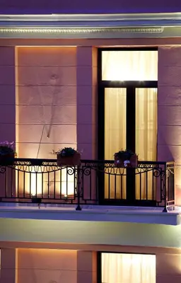 a balcony with a window with two plants on it at Sweet Home Hotel in Athens