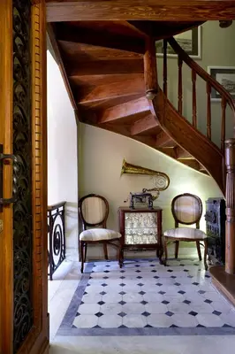 a living room with two chairs and a staircase at Sweet Home Hotel in Athens