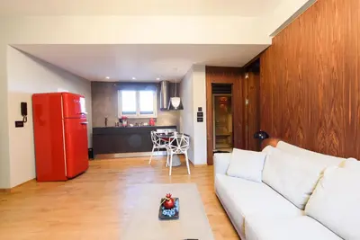 a living room with a white couch and a red refrigerator at Acropolis Dream Apartment in Athens