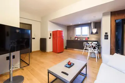 a living room with a white couch and a red refrigerator at Acropolis Dream Apartment in Athens