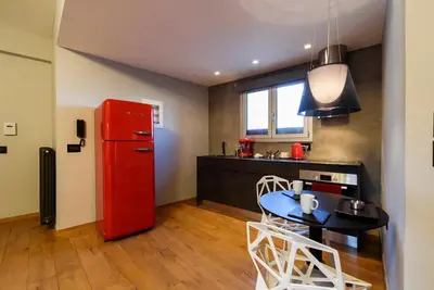 a kitchen with a red refrigerator and a table at Acropolis Dream Apartment in Athens
