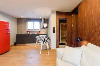 a living room with a couch and a table and a kitchen at Acropolis Dream Apartment in Athens