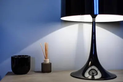 a table with a lamp and a cup on it at Acropolis Dream Apartment in Athens