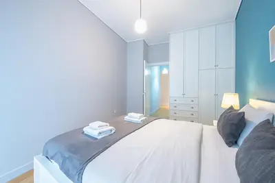 a bedroom with a white bed with two towels on it at Pame Rentals - 2BD & 2BA Home, 4 Min to Acropolis in Athens
