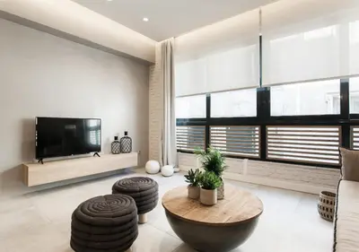 a living room with a table and a tv at Designer Apartment - stroll to the Acropolis in Athens
