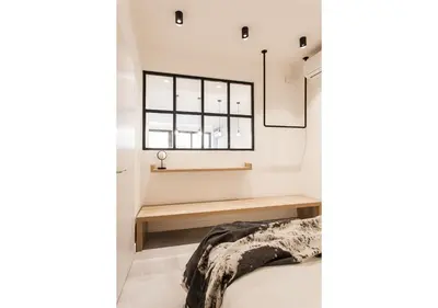 a bedroom with a bed and a window at Designer Apartment - stroll to the Acropolis in Athens