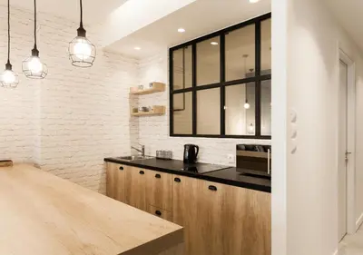 a kitchen with a wooden counter top and a window at Designer Apartment - stroll to the Acropolis in Athens
