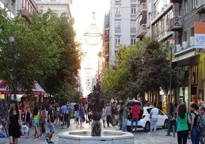 a crowd of people walking around a fountain in a city at Designer Apartment - stroll to the Acropolis in Athens