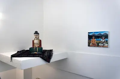 a statue sitting on a shelf next to a painting at Central Stay Athens in Athens