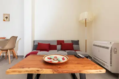 a living room with a table and a couch at Central Stay Athens in Athens