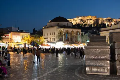 a crowd of people walking in front of a building at Central Stay Athens in Athens