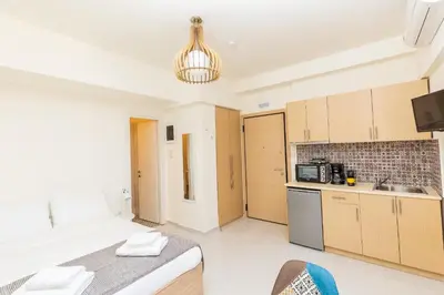 a kitchen with a large bed in a room at Central Stay Athens in Athens