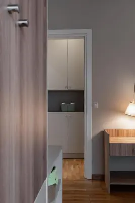 a kitchen with white cabinets and a table at Absolute Athens VI in Athens