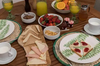 a wooden table topped with plates of food and fruit at Absolute Athens VI in Athens