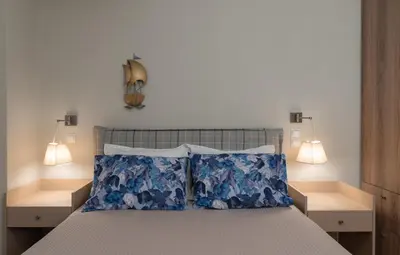 a bedroom with a bed with two lamps on it at Absolute Athens VII in Athens