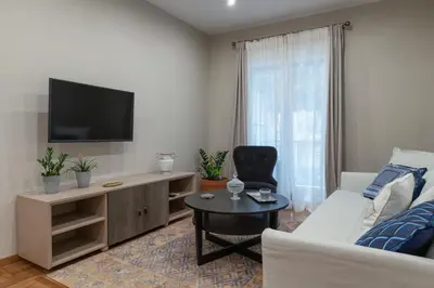 a living room with a couch and a tv at Absolute Athens VII in Athens