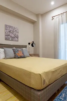 a large bed in a bedroom with a window at Absolute Athens VII in Athens